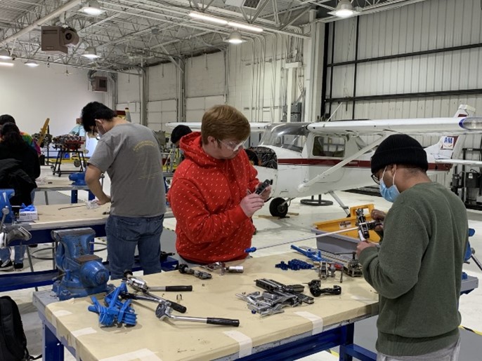 Students repairing parts