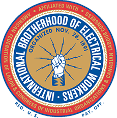 Badge of the International Brotherhood of Electrical Workers. A blue ring around a gold field showing light coming out of a raised fist. 