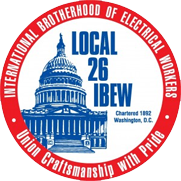 Badge of the Local 26 International Brotherhood of Electrical Workers. A red ring around ablue building. 